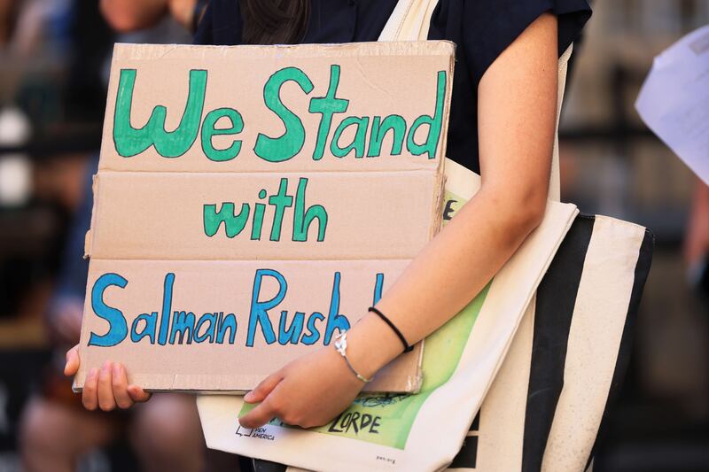 Supporters carry home-made signs. Getty Images / AFP
