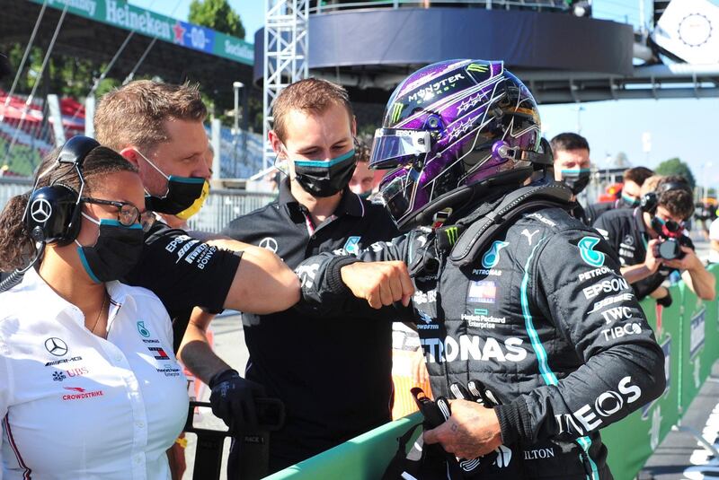 epa08648819 British Formula One driver Lewis Hamilton of Mercedes-AMG Petronas (R) greets his team members after he took pole position the qualifying session of the Formula One Grand Prix of Italy at the Monza race track, Monza, Italy 05 September 2020. The 2020 Formula One Grand Prix of Italy will take place on 06 September 2020.  EPA/Jenifer Lorenzini / Pool