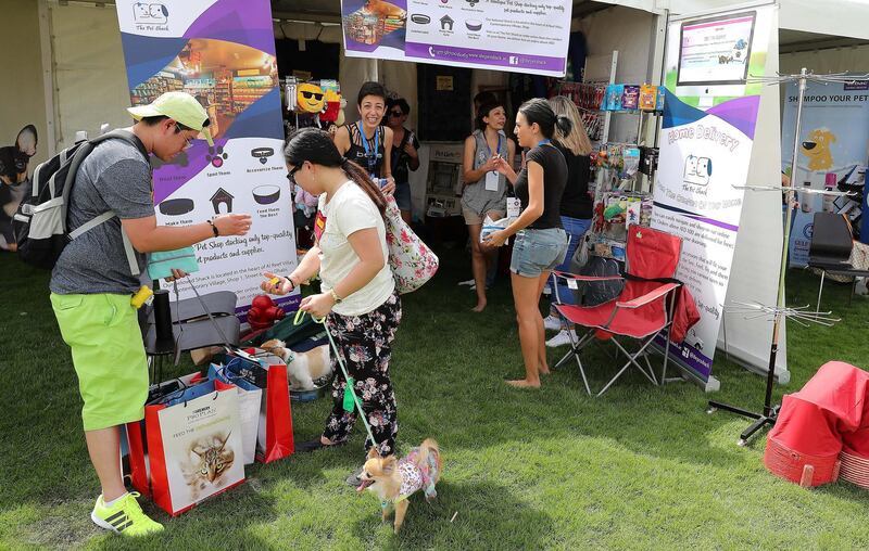 ABU DHABI , UNITED ARAB EMIRATES , APRIL 13   – 2018 :- People with their pets at the pet shop during the pet festival held at DU arena on Yas Island in Abu Dhabi. ( Pawan Singh / The National ) For News