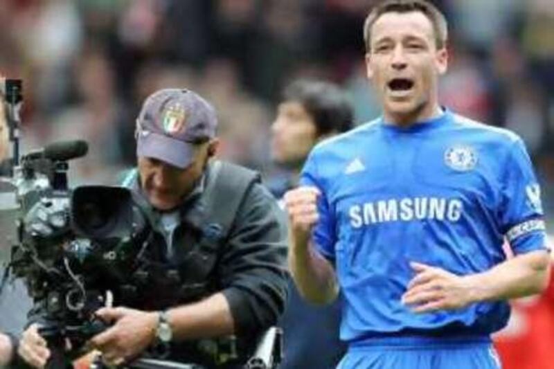A television camera follows Chelsea's Captain John Terry (R) after the game against Liverpool during the Premiership football match at Anfield in Liverpool on May 2, 2010. Chelsea won the game 2-0. AFP PHOTO / Paul Ellis

FOR EDITORIAL USE ONLY Additional licence required for any commercial/promotional use or use on TV or internet (except identical online version of newspaper) of Premier League/Football League photos. Tel DataCo +44 207 2981656. Do not alter/modify photo.