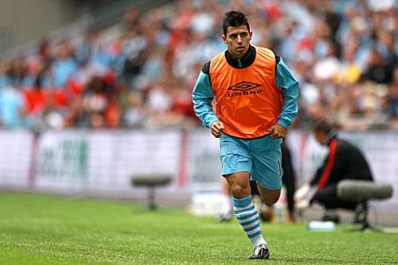 Manchester City’s Sergio Aguero warms up on the touchline at Wembley Stadium, but Roberto Mancini could not field him in the final minutes because he needed ‘tall players for set pieces’.