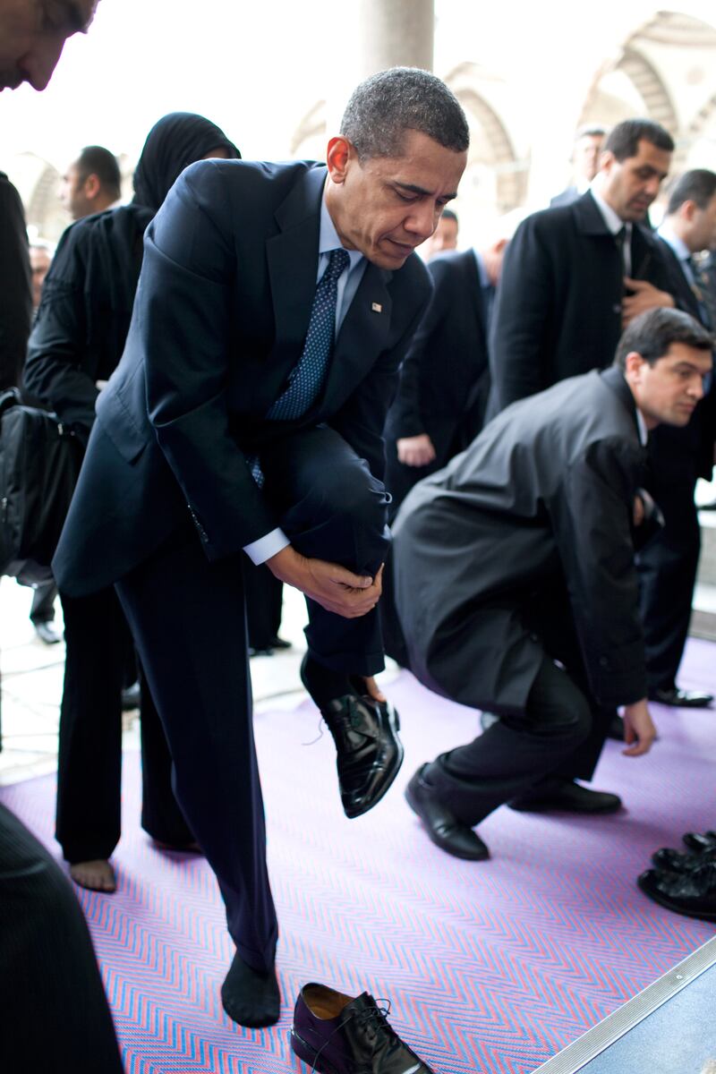 Mr Obama removes his shoes as he prepares to visit the Blue Mosque on April 7, 2009, in Istanbul, Turkey. Photo: The National Archives