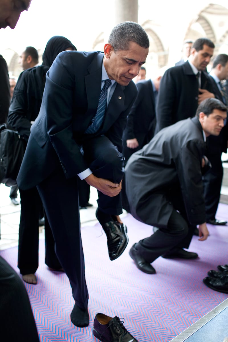 Mrk Obama removes his shoes as he prepares to visit the Blue Mosque April 7, 2009, in Istanbul, Turkey. Photo courtesy of the National Archives