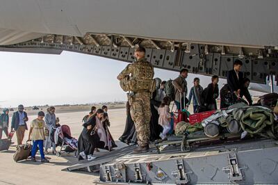 British citizens and dual nationals board a military plane at the airport in Kabul, Afghanistan. Ministry of Defence 