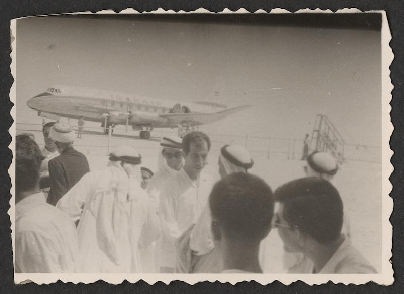 A reception for Rashid bin Saeed Al Maktoum during the grand opening of the Dubai Airport with an Iran Air plane in the background, 1960. Copyright Abdulghafoor Al Qasim
