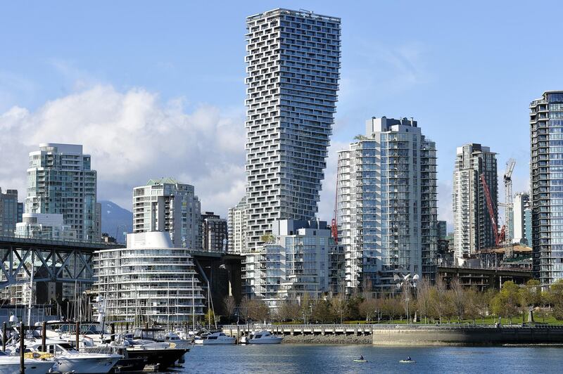 Kayakers paddles past the Vancouver House building under construction in Vancouver, British Columbia, Canada, on Monday, April 8, 2019. Government policies to tame the housing market -- from new taxes to stricter mortgage regulations -- have fueled a plunge in sales to the weakest since the global financial crisis. Prices are down 8.5 percent from their peak in June, according to the Real Estate Board of Greater Vancouver. Photographer: Jennifer Gauthier/Bloomberg