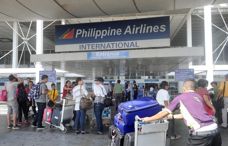 Passengers enter the Philippine Airlines passenger terminal at Manila airport. Two local billionaires have offered to build a new hub for the capital. AFP Jay Directo / AFP

