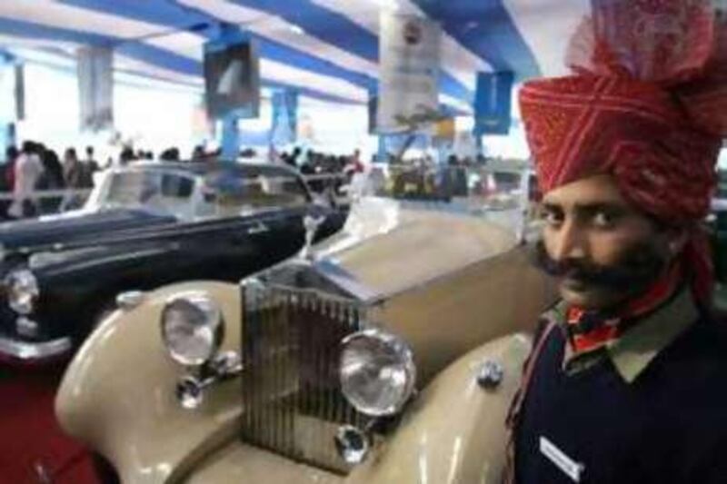 (FILES) In this picture taken on January 16, 2008, An Indian security guard wearing a traditional turban stands guard next to a 1935 Rolls Royce vintage car at the nineth Auto Expo in New Delhi.  India is minting new millionaires at a faster pace than anywhere else in the world, buoyed by a fast-growing economy, according to a new study. There were an estimated 123,000 millionaires in India at the end of 2007 -- 22.7 percent more than in the previous 12 months, said the Asia-Pacific Wealth Report, compiled by US investment bank Merrill Lynch and consultants Capgemini     AFP PHOTO/MANAN VATSYAYANA/FILES *** Local Caption ***  353169-01-08.jpg
