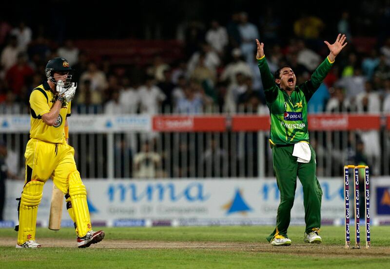 Pakistan's Saeed Ajmal, right, celebrates taking the wicket of Australia's Glenn Maxwell, left, during the first cricket ODI match of a three match series between Australia and Pakistan at Sharjah Cricket Stadium, in Sharjah, United Arab Emirates, Tuesday, Aug. 28, 2012. (AP Photo/Hassan Ammar) *** Local Caption ***  Mideast Emirates Pakistan Australia Cricket.JPEG-09bb0.jpg