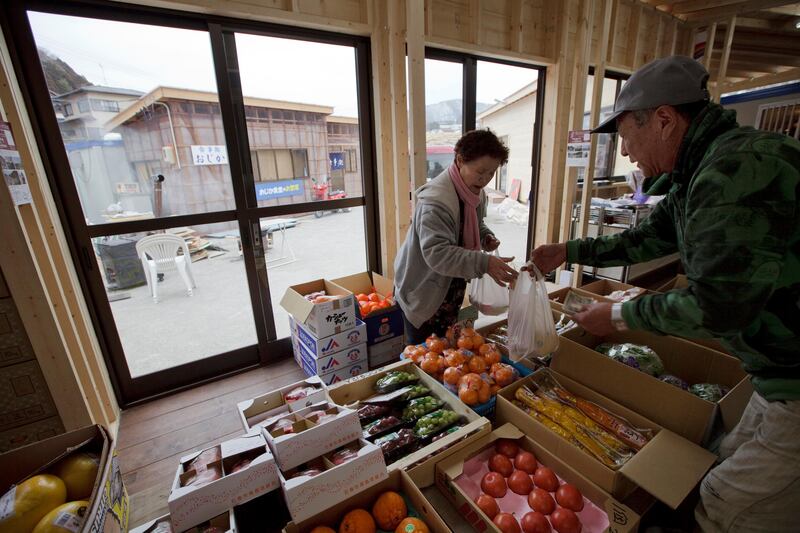 Customer shops at temporary shopping mall in Onagawa in Miyagi prefecture, Japan on Feb 29, 2012. Thousands of volunteers, including with the Peace Boat, have been helping to rebuild the town which was swept away by the massive tsunami hit northern Japan on March 1, 2011.
Photo by Kuni Takahashi