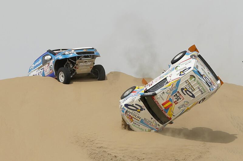 The Mitsubishi of Cristina Gutierrez Herrero and co-driver Gabriel Moiset Ferrer, both of Spain, turns over during the first stage of the 2018 Dakar Rally between Lima and Pisco, Peru. Ricardo Mazalan / AFP Photo