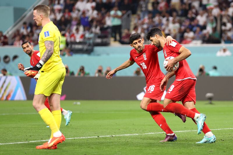 Mehdi Taremi celebrates with Mehdi Torabi after scoring. Getty