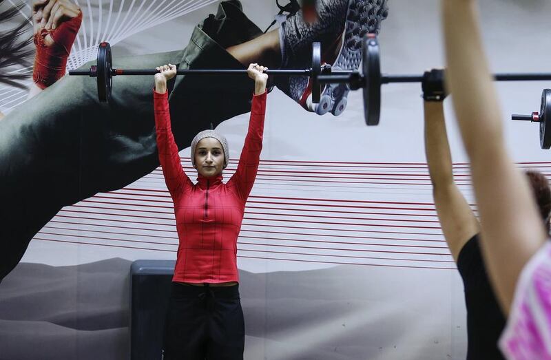 Emirati fitness instructor Shaikha Nasser puts her charges through a Body Pump session at Fitness 360 in Dubai. Sarah Dea / The National