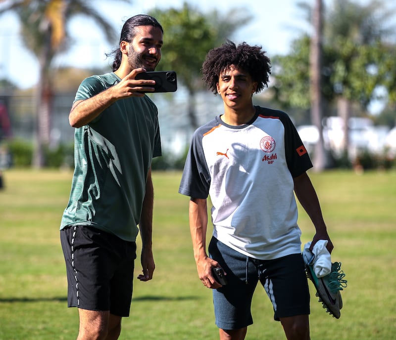 Manchester City's Rico Lewis with a fan at the Emirates Palace.