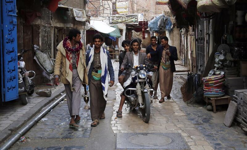 epaselect epa07472092 Yemenis walk through a market in the old quarter of Sana'a, Yemen, 29 March 2019. Yemen has been engulfed in a four-year conflict since the Saudi-led coalition launched its military campaign to roll back the Houthi rebels and reinstate the country's exiled government in the capital Sana'a.  EPA/YAHYA ARHAB