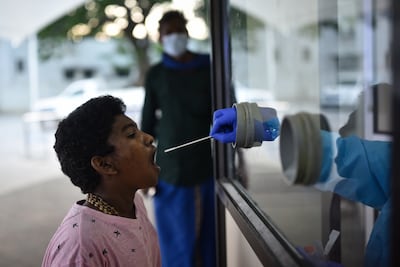 A health worker collects a swab sample after a sharp surge in Omicron variant cases, in Chennai, India. EPA 