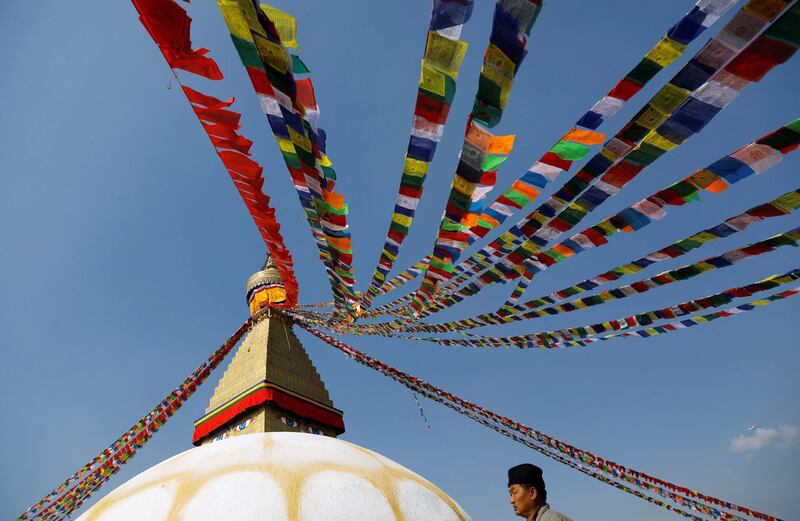 A man offers prayers by circling around the dome of Boudhanath Stupa, a UNESCO world heritage site famous among Buddhist devotees and tourists, in Kathmandu, Nepal. Reuters