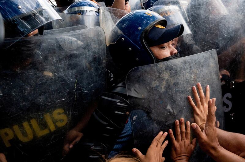 Police block activists during a protest denouncing the proclamation of the new Philippine President and Vice President in Quezon City on May 25. Reuters