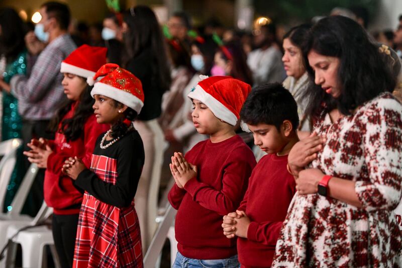 Worshippers gather for Christmas Eve midnight mass at St Joseph's Cathedral, Abu Dhabi. Khushnum Bhandari / The National
