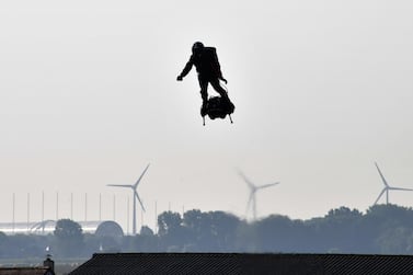 Franky Zapata (C) stands on his jet-powered "flyboard" as he takes off from Sangatte, northern France, attempting to fly across the 35-kilometre (22-mile) Channel crossing in 20 minutes, while keeping an average speed of 140 kilometres an hour at a height of 15-20 metres above the sea on July 25, 2019. AFP/Denis Charlet