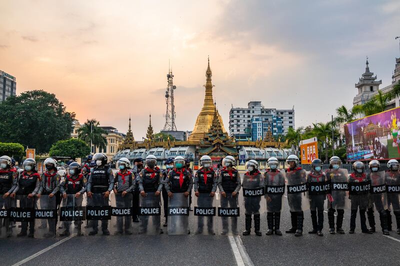 Riot police man a barrier in front of the Yangon City Hall in Yangon, Myanmar. Getty Images