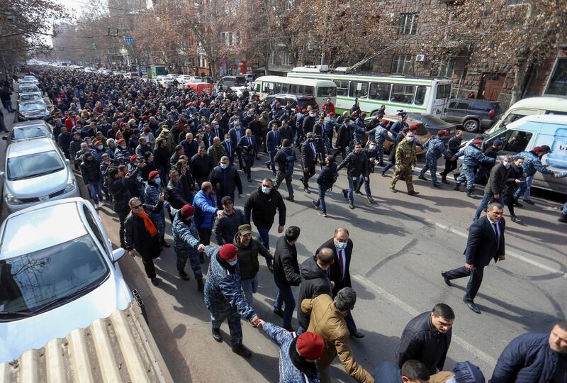 Armenian Prime Minister Nikol Pashinyan and his supporters march during a rally in Yerevan, Armenia. Pashinyan warned of an attempted military coup against him after the army demanded he and his government resign. Reuters