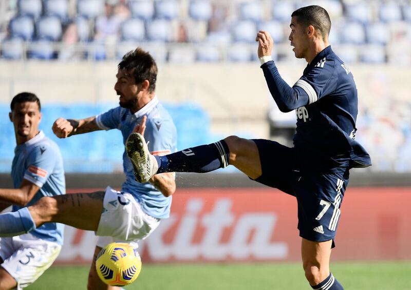 Juventus' Portuguese forward Cristiano Ronaldo (R) shoots and scores a goal during the Italian Serie A football match between Lazio (SSL) and Juventus (JFC) , at the Olympic stadium in Rome on November 8, 2020. (Photo by Filippo MONTEFORTE / AFP)