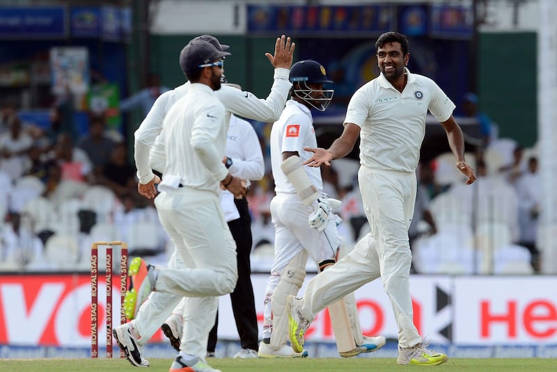 Indian cricketer Ravichandran Ashwin (R) celebrates with his teammates after he dismissed Sri Lankan cricketer Upul Tharanga during the second day of the second Test match between Sri Lanka and India at the Sinhalese Sports Club (SSC) Ground in Colombo on August 4, 2017. / AFP PHOTO / LAKRUWAN WANNIARACHCHI