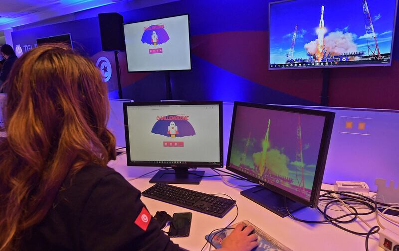 An employee of Tunisia's Telnet telecommunications group watches the launch of Russia's Soyuz-2.1a carrier rocket from the Baikonur cosmodrome. AFP