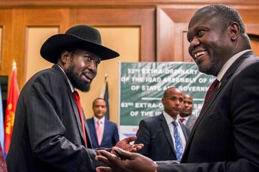 South Sudan's President Salva Kiir, left, and opposition leader Riek Machar shake hands during peace talks in Addis Ababa, Ethiopia in June. AP
