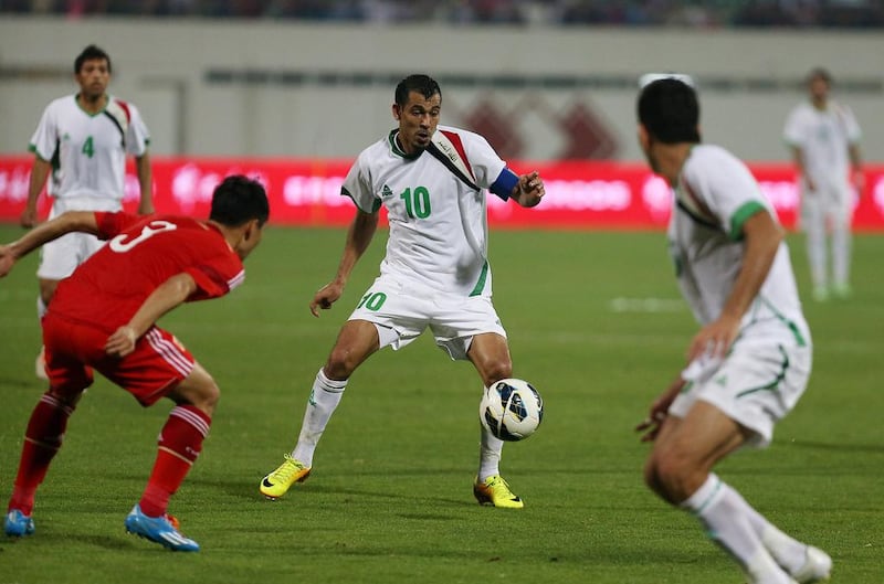 Younus Mahmood, centre, in action during the Asian Cup Qualifier match between Iraq and China at Sharjah football stadium in Sharjah. Iraq won the match by 3 - 1. Pawan Singh / The National

