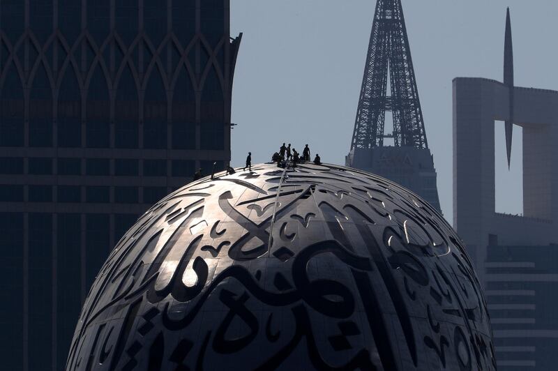 DUBAI, UNITED ARAB EMIRATES, December 9 – Workers working on the Museum of The Future on Sheikh Zayed road in Dubai. (Pawan Singh / The National) For Standalone/Online/Instagram/Big Picture