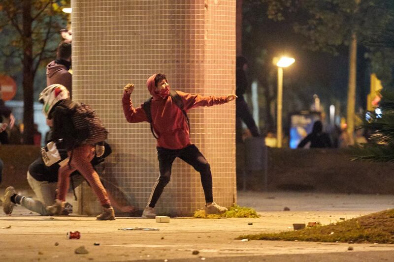 Demonstrators fling stones during a protest in Girona, Spain.  EPA