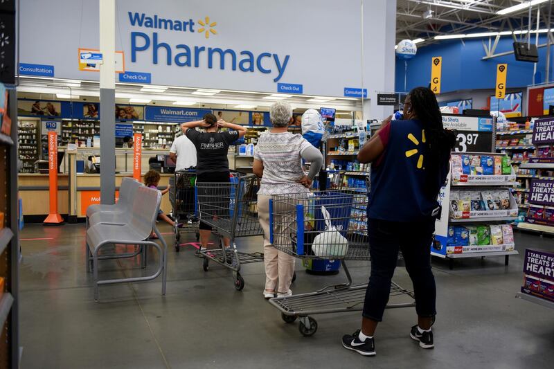 Shoppers wait in line to be served at the pharmacy of a Walmart Inc. store ahead of Hurricane Florence in Charlotte, North Carolina, US Callaghan O'Hare / Bloomberg