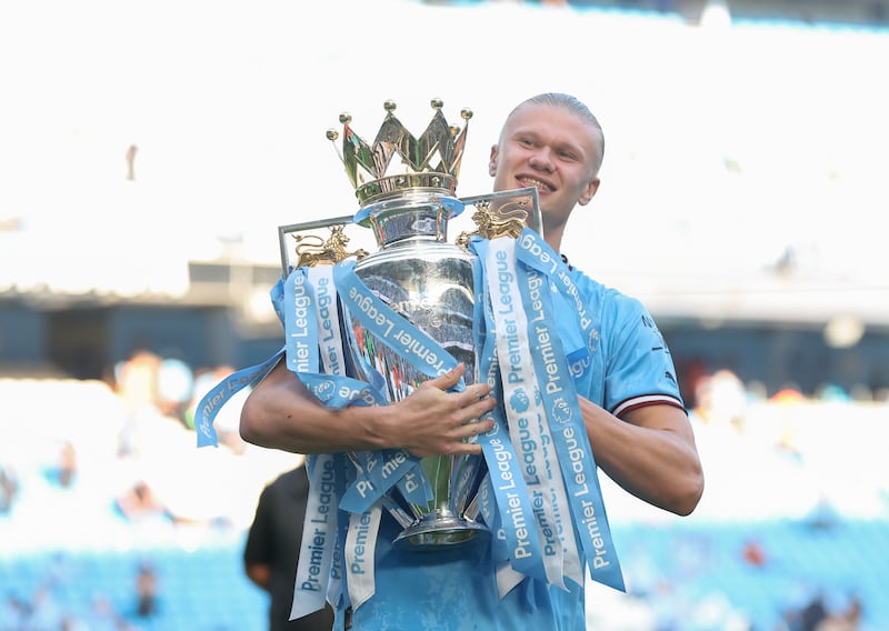 manchester CIty striker Erling Haaland of Manchester City celebrates with the Premier League trophy. Getty