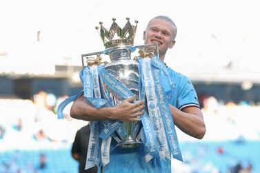 MANCHESTER, ENGLAND - MAY 21: Erling Haaland of Manchester City celebrates with the Premier League trophy following the Premier League match between Manchester City and Chelsea FC at Etihad Stadium on May 21, 2023 in Manchester, England. (Photo by Catherine Ivill / Getty Images)