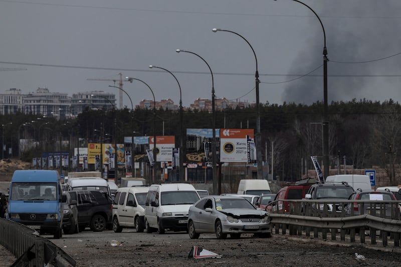 Cars are left abandoned on a road as residents flee the town of Irpin, Ukraine after days of heavy shelling. Reuters