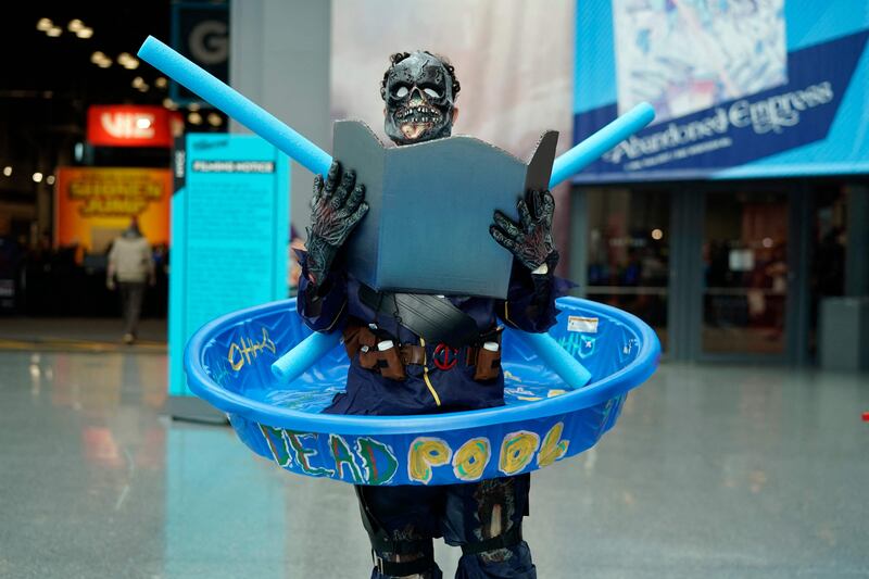 An attendee cosplaying as Deadpool arrives at New York Comic Con. Timothy A Clary / AFP