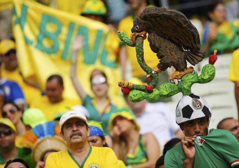 A fan of Mexico poses before his team's 2014 World Cup Group A match against Brazil on Tuesday in Fortaleza, Brazil. Kai Pfaffenbach / Reuters