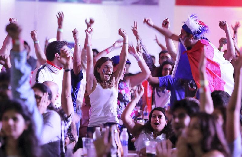 DUBAI , UNITED ARAB EMIRATES , JULY 15 – 2018 :- Supporters of France celebrating after France won the World Cup final match against Croatia at The Dome in Dubai Sports City in Dubai. ( Pawan Singh / The National )  For News. Story by Patrick