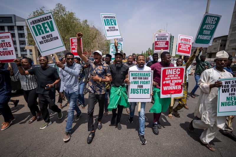 Demonstrators accusing the election commission of irregularities and disenfranchising voters protest in Abuja, Nigeria. AP
