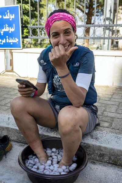 Nayla Cortas cools feet in icewater after running for 6 days, 12 hours and 15 minutes across the Lebanon Mountain Trail, Marjaayoun, Lebanon on Saturday May 1 2021. Matt Kynaston for The National