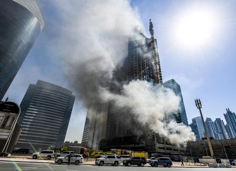 Smoke rises from a fire in a tower in the Business Bay area of Dubai. Karim Sahib / AFP