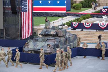 epa07694434 US Army soldiers walk by an armored Bradley Fighting Vehicle on display in front of the Lincoln Memorial for US Independence Day celebrations on the National Mall in Washington, DC, USA, 04 July 2019. The 'Salute to America' Fourth of July activities include remarks by US President Trump, a parade, military flyovers and fireworks. EPA/ERIK S. LESSER