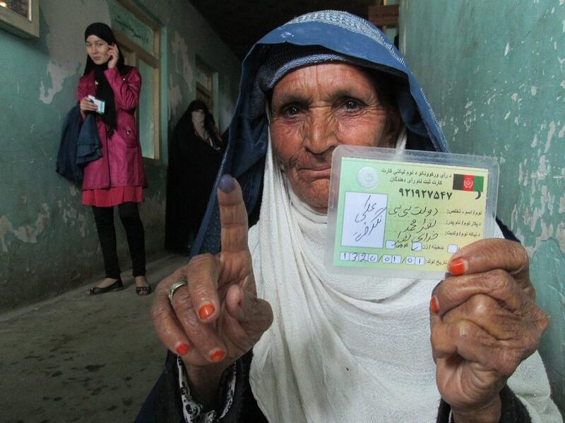 An Afghan woman shows her voters registration card after casting her ballot during the presidential elections in Kunduz, Afghanistan, 05 April 2014. Afghanistan began voting 05 April, for a new president amid fears of violence and insecurity. About 12 million voters are eligible to cast ballots at some 6,400 polling centers across the country, according to IEC. Around 400,000 security forces have been deployed.   Nasir Waqif / EPA