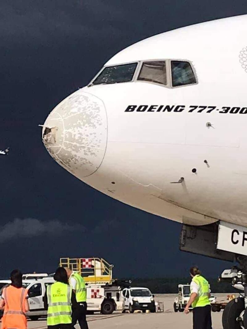 The nose of the plane can be seen with multiple dents and abrasions as a result of the storm.