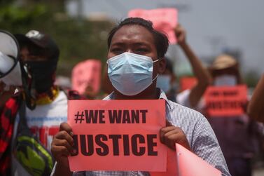 A demonstrator holds a placard during an anti-military coup protest in Mandalay, Myanmar. EPA