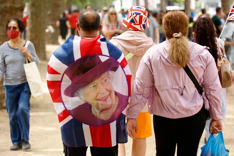 People walk along The Mall, outside Buckingham Palace on the second day of celebrations. AP Photo