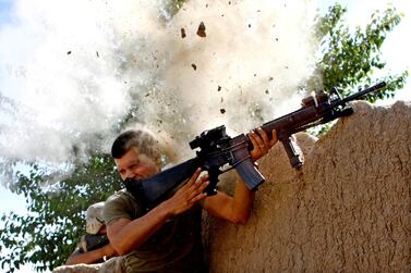 Sergeant William Olas Bee, a US Marine from the 24th Marine Expeditionary Unit, has a close call after Taliban fighters opened fire near Garmsir in Helmand Province of Afghanistan, May 18, 2008. Reuters