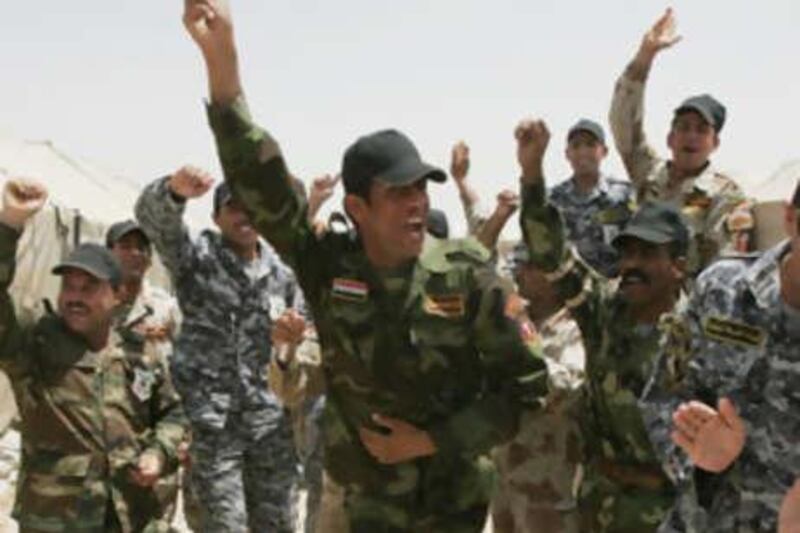Members of the Iraqi police and army celebrate after graduation. The UAE has helped train officers at facilities in the Emirates.